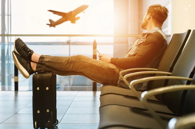 A student waiting to board a plane to his study abroad destination